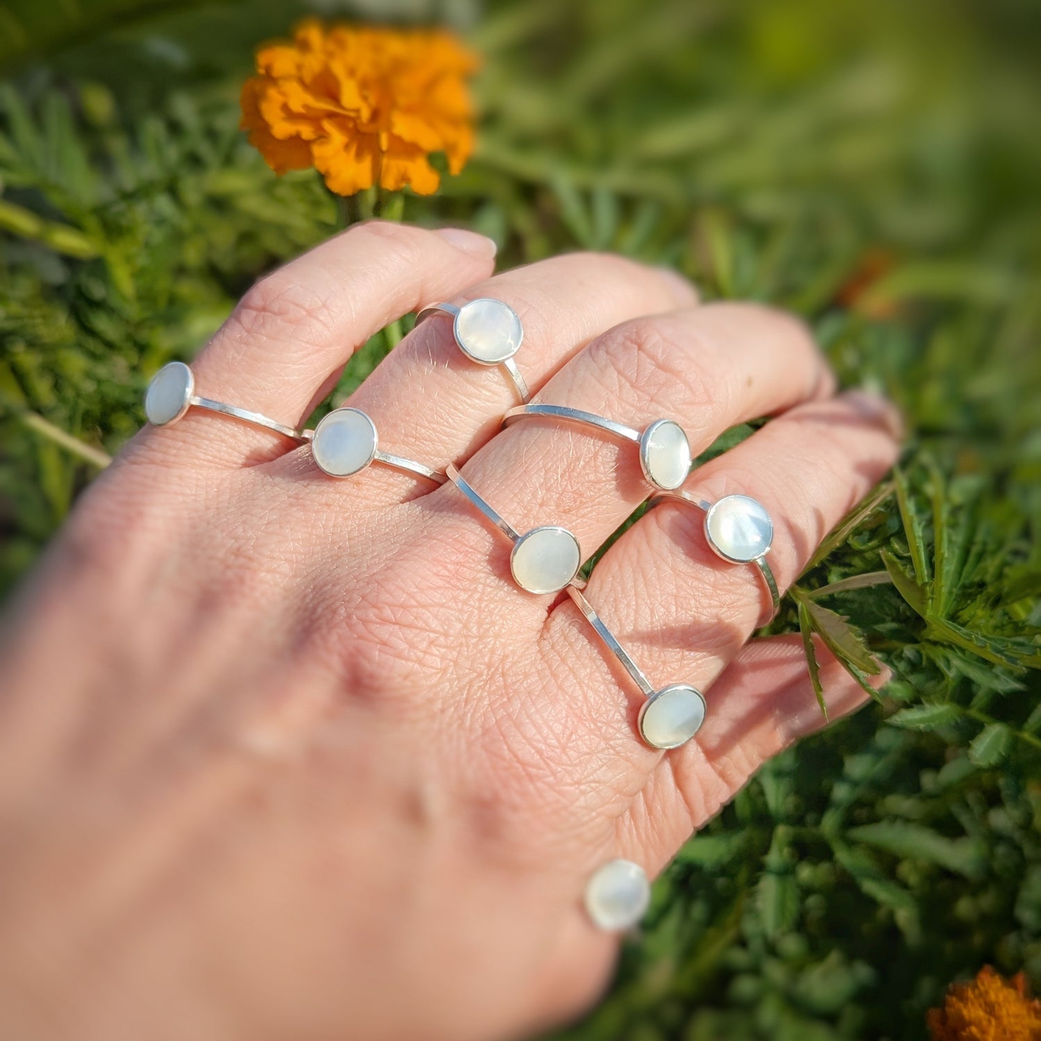 Luminous green onyx gemstone set in sterling silver ring between two birch silver stacker bands 